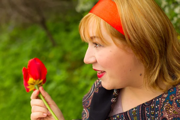 Charming rosy-cheeked young woman dressed in Russian style with — Stock Photo, Image