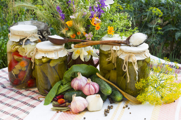 Banks with pickled vegetables - cucumbers, tomatoes, zucchini, and spice