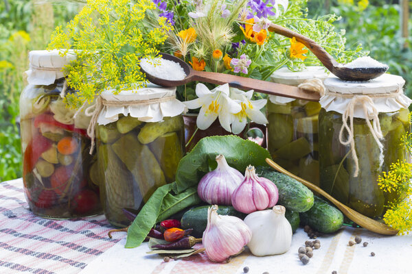 Banks with pickled vegetables - cucumbers, tomatoes, zucchini, and spice