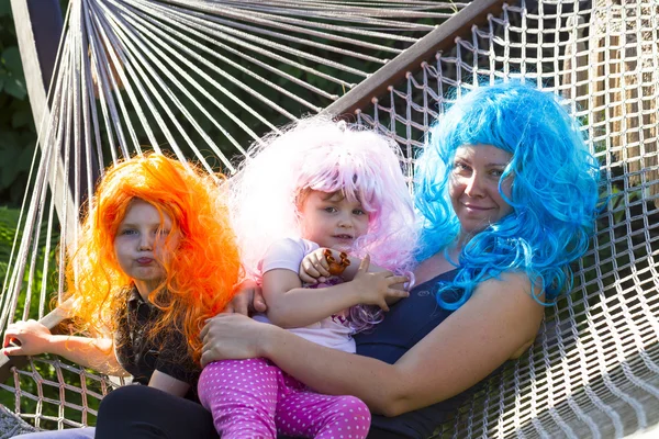 Portrait of a little girl in the carnival wig of hair color — Stock Photo, Image