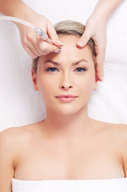 woman getting microdermabrasion procedure