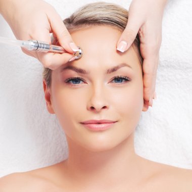 woman getting microdermabrasion procedure