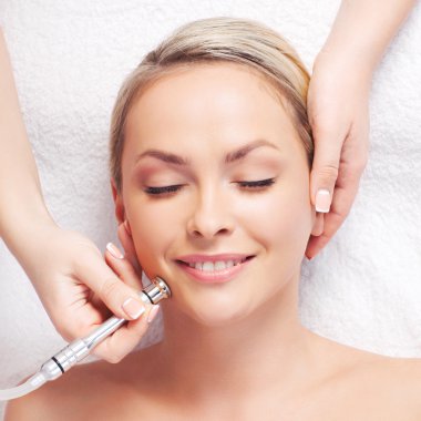 woman getting microdermabrasion procedure
