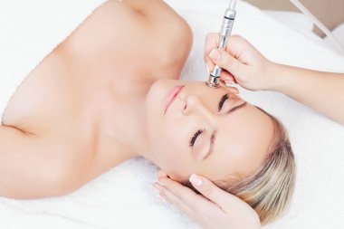 woman getting microdermabrasion procedure