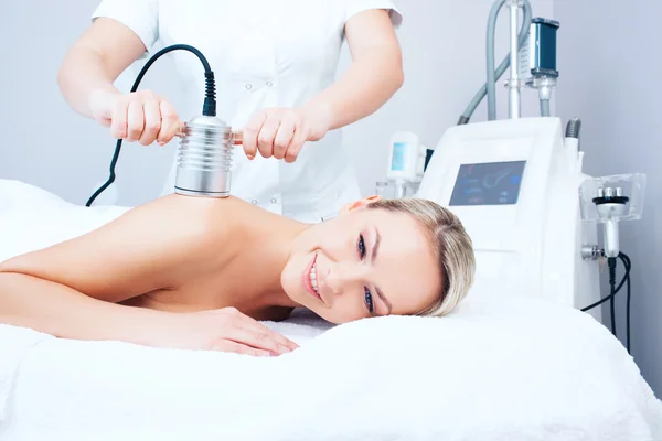 Young woman getting cavitation procedure — Stok fotoğraf