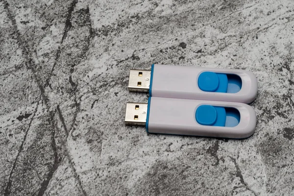 two new usb flash drives on a gray abstract background