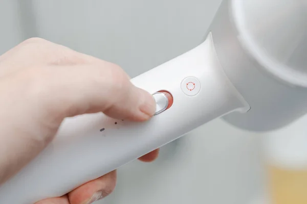 hair dryer for drying hair in the hand of a person, switching modes