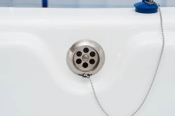 White Bathtub Hole Water Drain Blue Stopper Chain Royalty Free Stock Photos