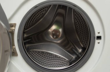 The door of an empty washing machine is open