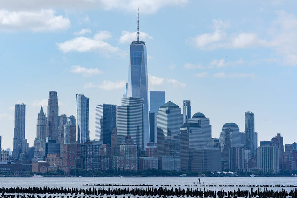 New York, NY - USA - July 30, 2021: a horizontal view of Lower Manhattan's Financial District, featuring the iconic World Trade Center and the Hudson River.