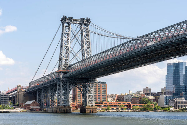 Brooklyn, NY - USA - July 30, 2021: Landscape view of the Williamsburg Bridge, a suspension bridge in New York City spanning across the East River, connecting Manhattan with Brooklyn.