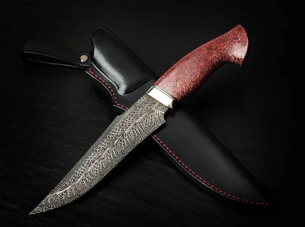 Hunting knife handmade on a black background. Leather Sheath Handmade