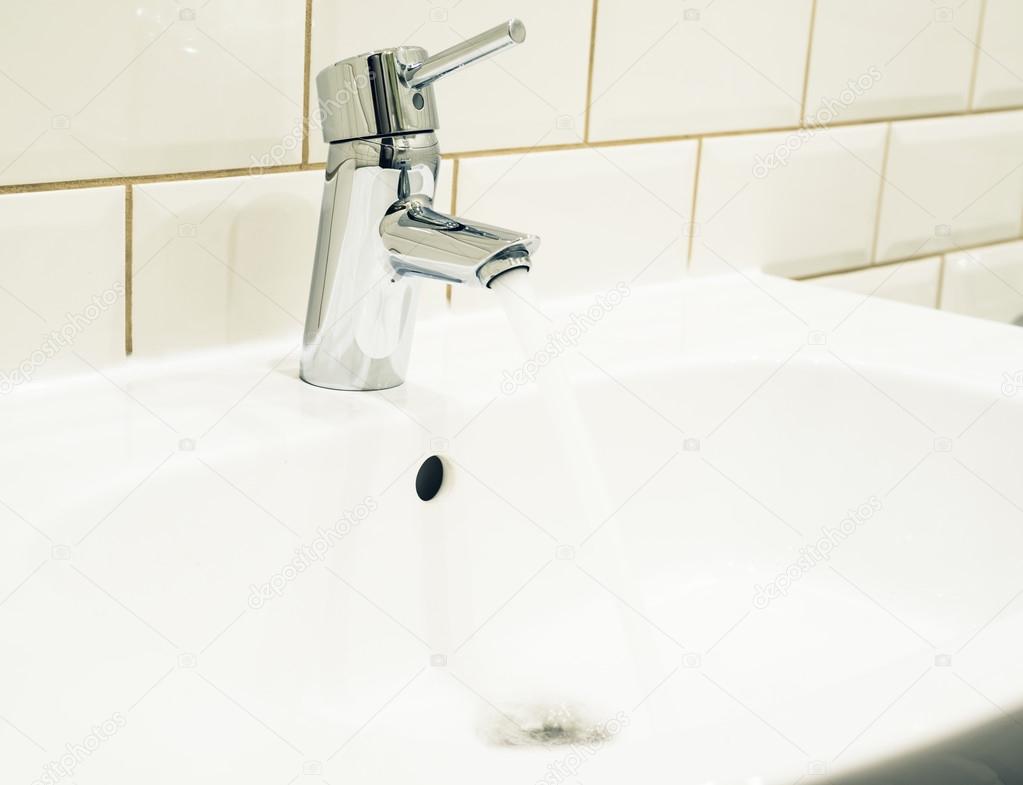 Faucet and basin in bathroom