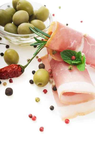 Prosciutto with rosemary and olives — Stock Photo, Image