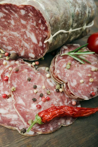 Salami with pepper and rosemary — Stock Photo, Image