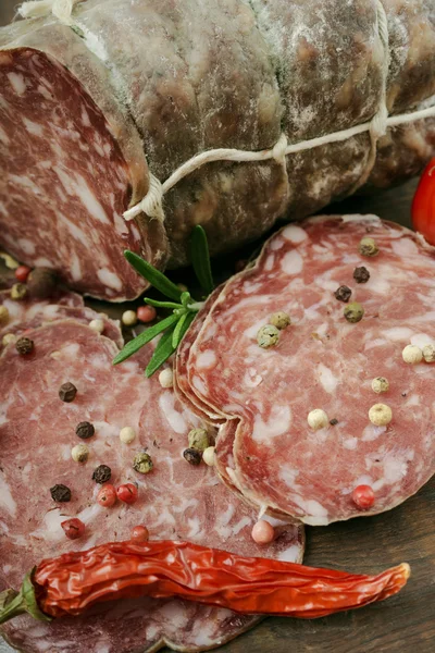 Sliced smoked sausage with spices — Stock Photo, Image