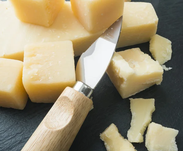 Parmesan cheese with knife — Stock Photo, Image