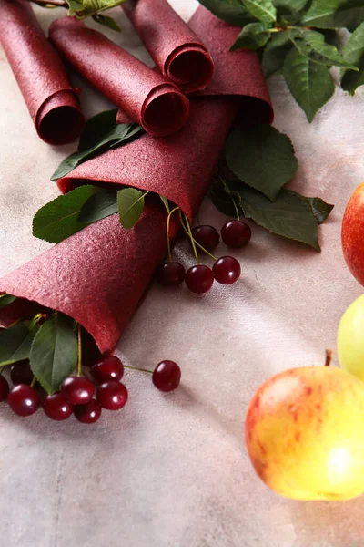 Cherry pastille on a light background. The concept of storing berries for the winter. Apples and cherries. Top view.