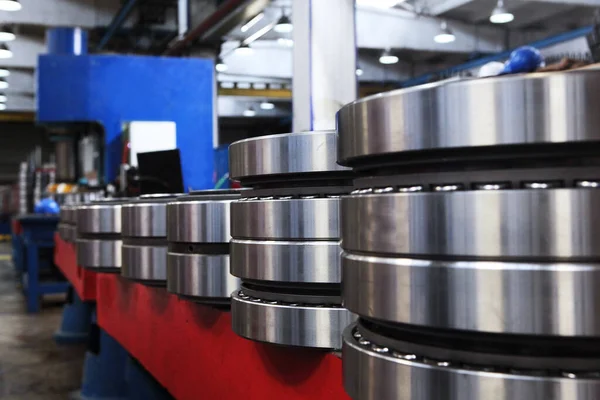 A large number of large-sized bearings.Ready-made large-diameter bearings stand in rows at the factory.Finished products of the bearing plant.Heavy industry concept. Metal products.