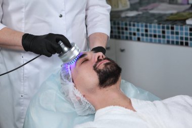 Erkekler için kozmetik donanım prosedürleri. Kozmetik kliniğinde bir adam. Gençliği korumak ve cilt bakımını sağlamak..