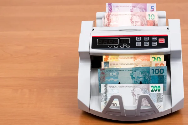 Brazilian money in a counting machine