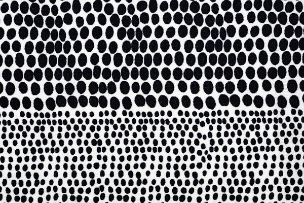Weißes Material in schwarzen Punkten, ein Hintergrund — Stockfoto