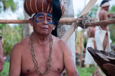 Meksika 'daki yerli köyünde başında başlık ve boynunda kolyeler olan yaşlı bir Maya erkeğinin yakın çekimi.