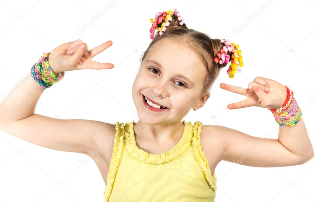 A smiling girl with a fashionable hairstyle with trendy handmade weaving bracelets  showing two hands victory gesture