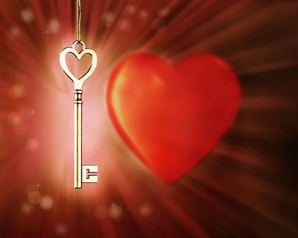 Goldene magische glühende Schlüssel auf dem Hintergrund mit einem Herz. — Stockfoto