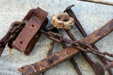 makro paslı çiviler, fındıklar, gri arka planda izole zincir.