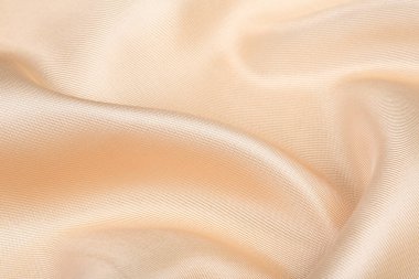 Saten kumaş şeftali rengi stüdyonun makro dokusu 