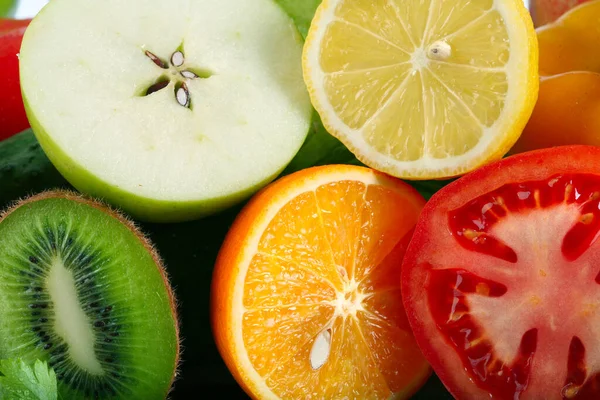 close-up of assorted cut ripe fruits and vegetables studio