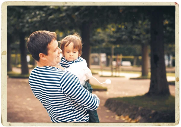 Family together on nature in stripes same clothes — Stock Photo, Image