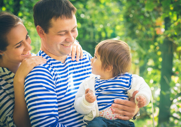 Family with little child in park