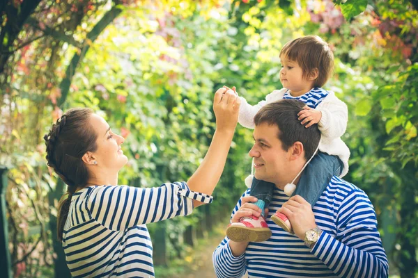 Familj med litet barn i park — Stockfoto