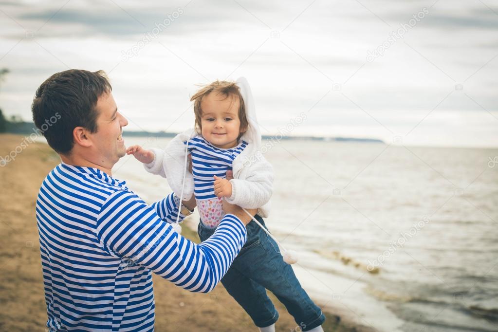 father holding daughter on hands