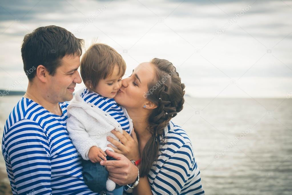 Parents holding little child on hands