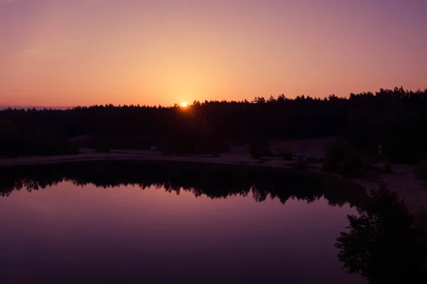 Солнце Светит Силуэтов Соснового Леса Отражается Зеркальной Воде Озера — стоковое фото