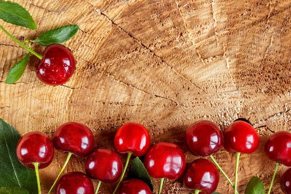 Cherries on wooden table — Stock Photo, Image