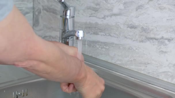 Man washes his hands with soap under the streem at home — Stock Video