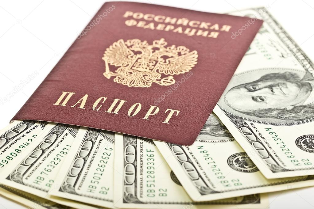 Russian passport with American hundred dollar bills