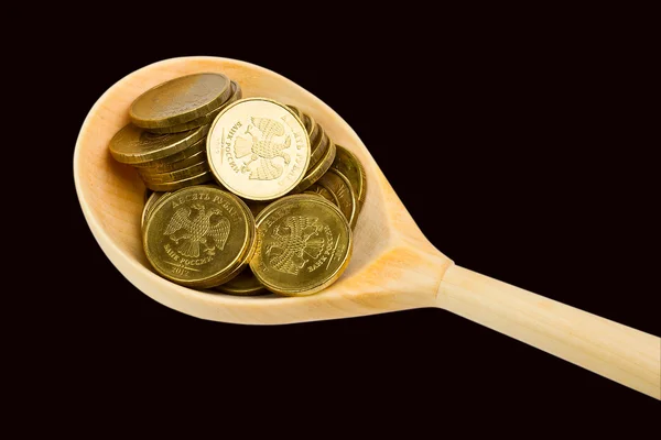 Cuchara con monedas sobre fondo negro —  Fotos de Stock