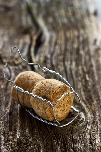 Champagne cork on a wooden board — Stock Photo, Image