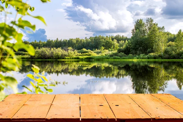 Forest lake and wooden board background — Stock Photo, Image