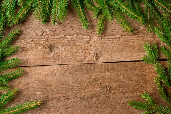 Green fir branches on a wooden background Stock Picture