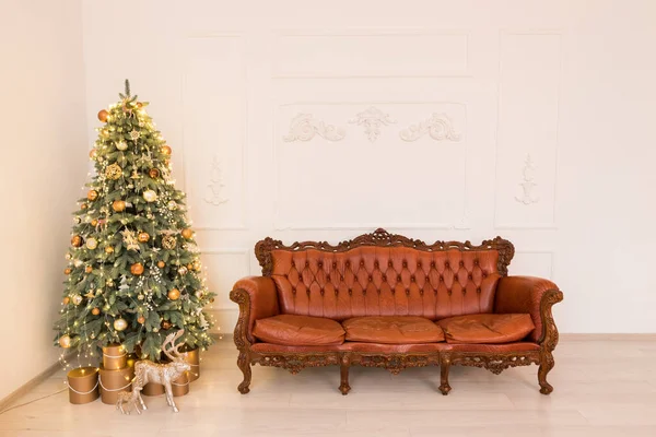 Christmas light interior studio. Interior room with festive tree and brown sofa