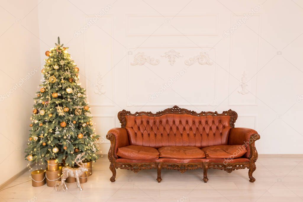Christmas light interior studio. Interior room with festive tree and brown sofa