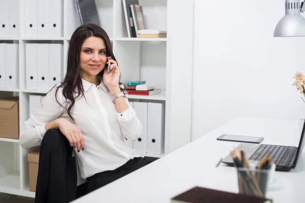 Femme d'affaires avec ordinateur portable au bureau, au travail, parlant au téléphone — Photo