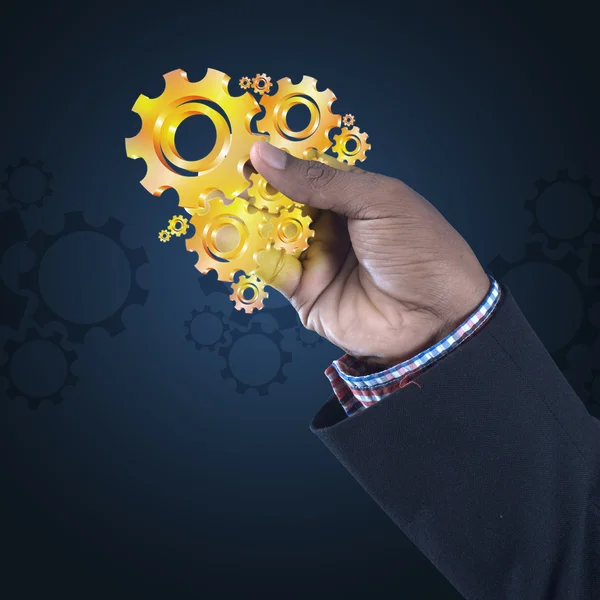 Businessman showing gears cogs — Stock Photo, Image