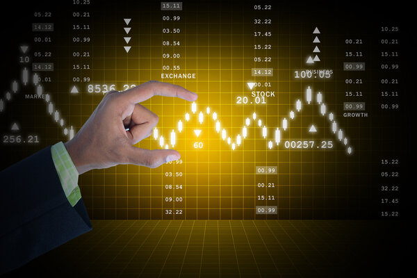 Businessman holds the stock chart